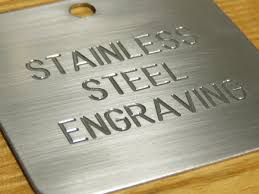 Standard fiber laser deep engraving on stainless steel showing 'STAINLESS STEEL ENGRAVING' text